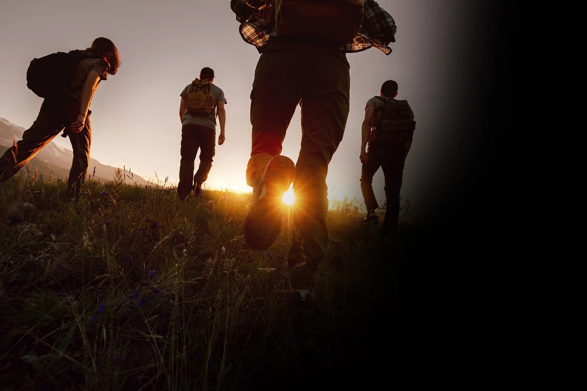 Team hiking at sunset